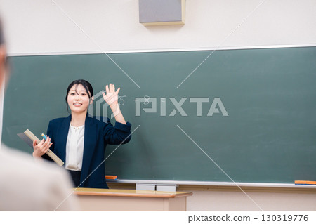 Female teacher teaching in the classroom 130319776