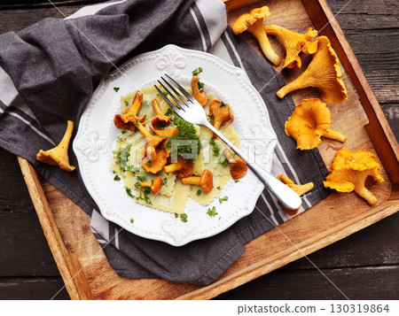 Italian ravioli with fresh roasted chanterelles and creamy parmesan cheese sauce Italian ravioli with fresh roasted chanterelles and creamy parmesan cheese sauce 130319864