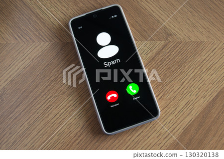 Incoming spam call on mobile phone on table 130320138