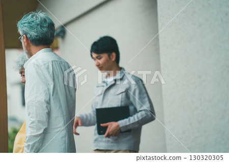 A young housing salesman and a senior couple 130320305