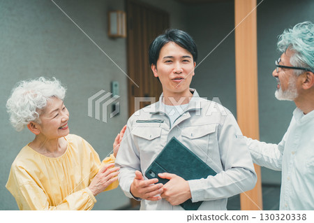 A new housing salesman who looks like a grandson and an elderly couple 130320338