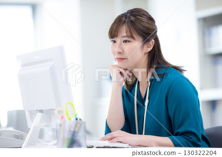 Business woman working on a computer 130322204