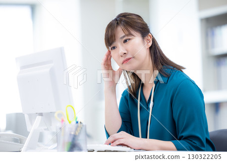 Business woman working on a computer 130322205