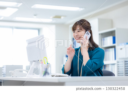 Business woman making a phone call on her smartphone 130322458