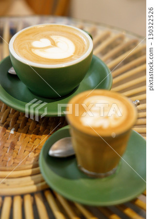 Cup of hot milk latte coffee and piccolo latte coffee on table by the window. 130322526