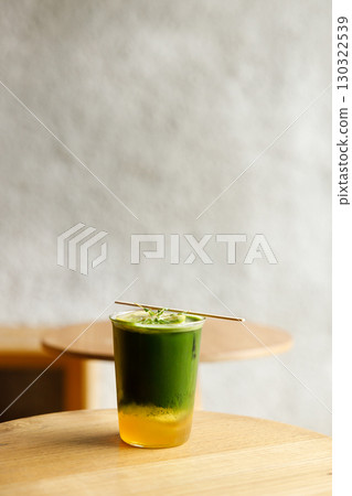 Creation beverage of fresh matcha tea, green tea and lemon juice on wooden table by the window. Creation beverage of fresh matcha tea, green tea and lemon juice on wooden table by the window. 130322539
