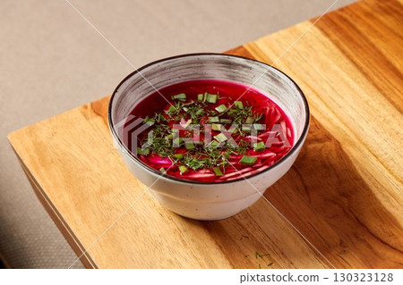 Delicious and Vibrant Beetroot Soup, enhanced with Fresh, Green Herbs for ultimate flavor 130323128