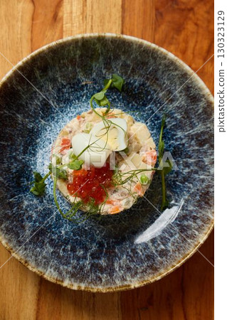 An Elegant Seafood Dish beautifully presented with exquisite caviar and vibrant microgreens An Elegant Seafood Dish beautifully presented with exquisite caviar and vibrant microgreens 130323129