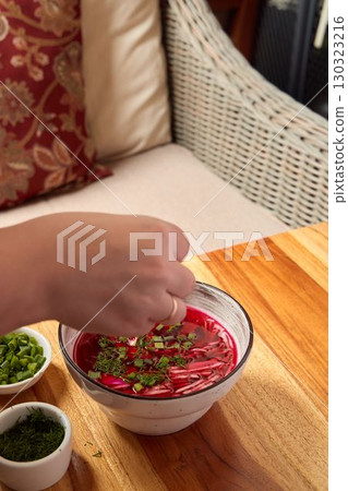 Garnishing a Delicious Bowl of Beetroot Soup with Fresh Herbs for an Enhanced Experience Garnishing a Delicious Bowl of Beetroot Soup with Fresh Herbs for an Enhanced Experience 130323216