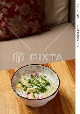 A Delicious and Aromatic Bowl of Fresh Herb Soup Presented on a Rustic Wooden Table 130323235