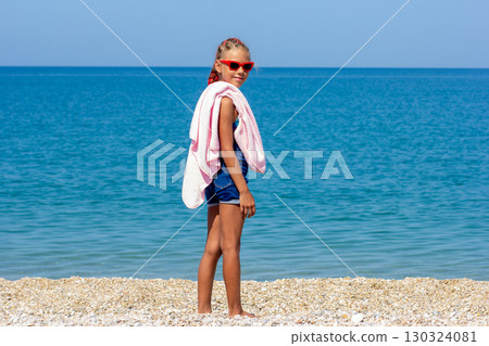 Child with towel on the beach Child with towel on the beach 130324081