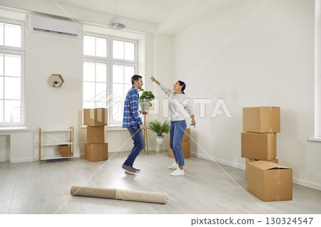 Happy couple dancing in their hoome on moving day Happy couple dancing in their hoome on moving day 130324547