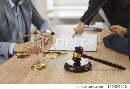 Male lawyer having team meeting with a client and discussing contract in the office. 130324550