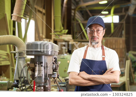 Portrait of a veteran craftsman working in a woodworking shop Portrait of a veteran craftsman working in a woodworking shop 130324825