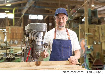 Portrait of a veteran craftsman working in a woodworking shop Portrait of a veteran craftsman working in a woodworking shop 130324826
