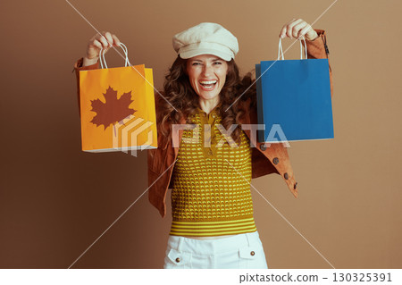 Smiling Woman Displays Autumn Shopping Bags 130325391