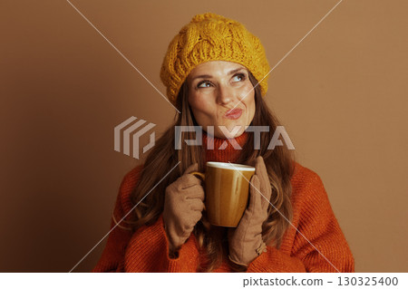 Thoughtful Woman with Warm Mug in Yellow Beret Thoughtful Woman with Warm Mug in Yellow Beret 130325400