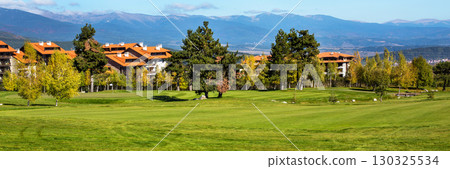 Panorama of Beautiful Landscape view, colorful trees, wooden chalets and mountains background Panorama of Beautiful Landscape view, colorful trees, wooden chalets and mountains background 130325534
