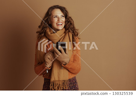 Joyful Woman Connected on Smartphone in Autumn Style Joyful Woman Connected on Smartphone in Autumn Style 130325539