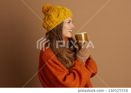 Smiling Side Profile of Woman with Warm Mug Smiling Side Profile of Woman with Warm Mug 130325558