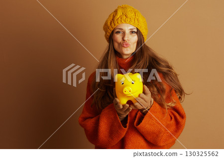 Playful Woman with Piggy Bank Pondering Savings 130325562