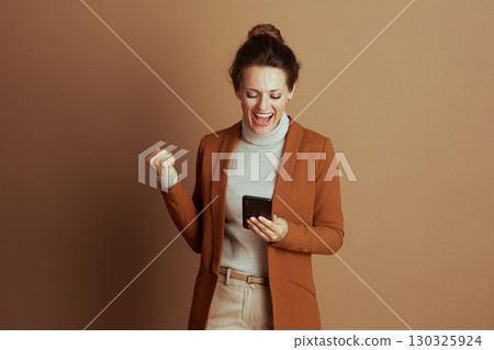 Businesswoman Celebrates Online Success with Triumph 130325924