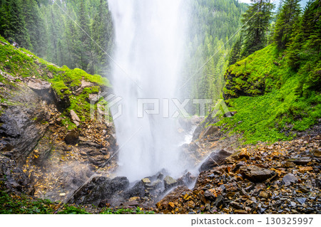 Johannes Waterfall cascades majestically amidst lush greenery in Obertauern, Austria. Visitors can enjoy the refreshing mist and serene beauty of this natural wonder year-round. Johannes Waterfall cascades majestically amidst lush greenery in Obertauern, Austria. Visitors can enjoy the refreshing mist and serene beauty of this natural wonder year-round. 130325997