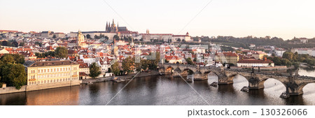 A breathtaking view of Prague at sunrise, showcasing the vibrant colors of dawn illuminating the medieval architecture. 130326066