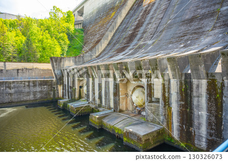 This structure showcases the Orlik Dam and Hydroelectric Power Station in Czechia, highlighting its concrete design and surrounding natural landscape on a sunny day. This structure showcases the Orlik Dam and Hydroelectric Power Station in Czechia, highlighting its concrete design and surrounding natural landscape on a sunny day. 130326073