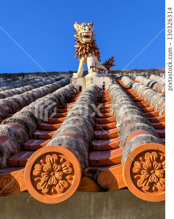 A Shisa (portrait) enshrined on a red tile roof in Maji, Okinawa 130326314