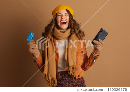 Laughing Woman with Credit Card and Smartphone Laughing Woman with Credit Card and Smartphone 130326376