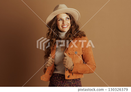 Stylish Woman Posing in Fall Suede Jacket and Fedora 130326379