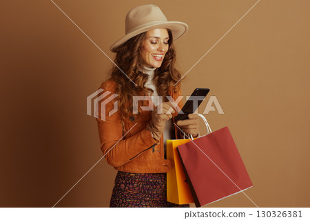 Fall Fashionista Browsing Phone with Purchases 130326381