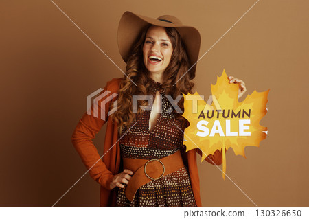 Enthusiastic Woman with Autumn Sale Sign 130326650