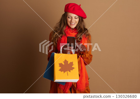 Engaged Woman Browsing Phone While Autumn Shopping Engaged Woman Browsing Phone While Autumn Shopping 130326680