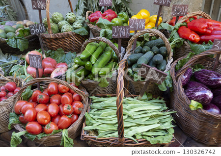 handmade wicker baskets with tomatoes, lettuces, artichokes, peppers, cucumbers, eggplants and beans 130326742