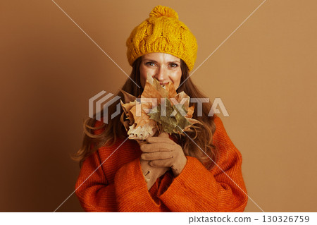Middle-Aged Woman with Bright Smile, Leaves Covering Face Middle-Aged Woman with Bright Smile, Leaves Covering Face 130326759