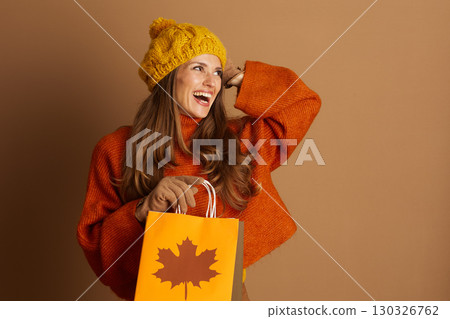 Joyful Woman with Autumn Shopping & Hand Gesture 130326762