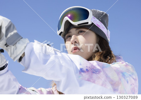 Cute woman enjoying snowboarding Cute woman enjoying snowboarding 130327089