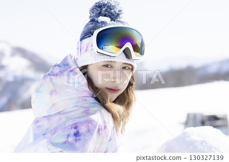 Cute woman enjoying the snowy mountains 130327139