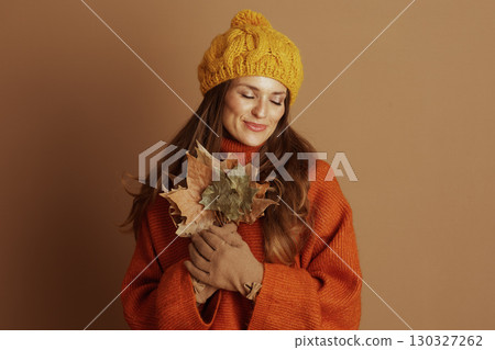 Serene Woman with Autumn Leaves, Eyes Closed 130327262