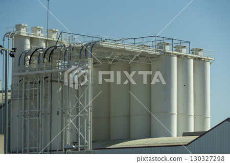 A large white building with a lot of tanks on it 130327298