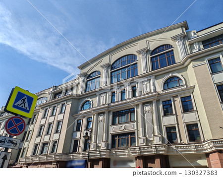 historical pink building with multiple floors, adorned with decorative features and air conditioning units on its windows. The combination of classic design and modern amenities highlights urban historical pink building with multiple floors, adorned with decorative features and air conditioning units on its windows. The combination of classic design and modern amenities highlights urban 130327383