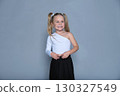 playful shot shows a little girl with a surprised expression, her hands pressed to her cheeks. The photo captures the energetic and fun nature of childhood, making it great for lifestyle and children 130327549