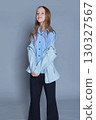 Carefree young spirit captured mid-turn, her attire speaking of both comfort and trend. Suitable for modern childrenswear editorials. 130327567