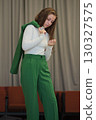 A portrait capturing a young woman in formal attire, her upward gaze suggesting ambition and focus in a modern setting. 130327575