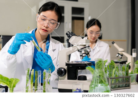 Team microbiologists and nutrition experts analyze molecular samples in advanced food science labs. 130327602