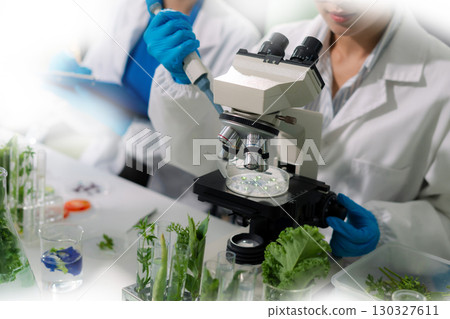 Team microbiologists and nutrition experts analyze molecular samples in advanced food science labs. Team microbiologists and nutrition experts analyze molecular samples in advanced food science labs. 130327611