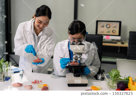 Team microbiologists and nutrition experts analyze molecular samples in advanced food science labs. Team microbiologists and nutrition experts analyze molecular samples in advanced food science labs. 130327623