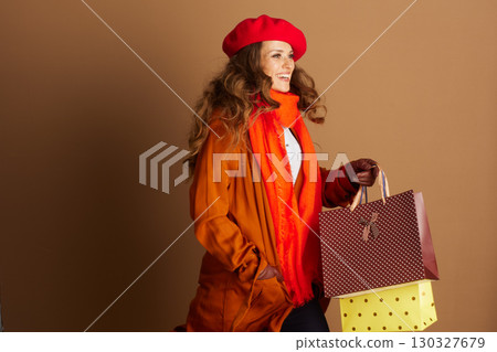 Stylish Woman Walking with Autumn Shopping Bags 130327679